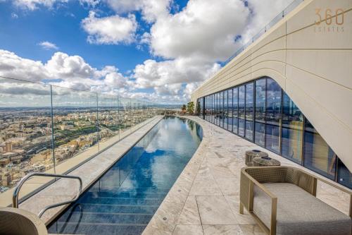 a view from the top of a building with a swimming pool at Official Apartments of Mercury Towers by MyMercury in St. Julianʼs