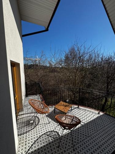 a patio with two chairs and a table on a balcony at Apartament Poranek w Sadzie in Białla