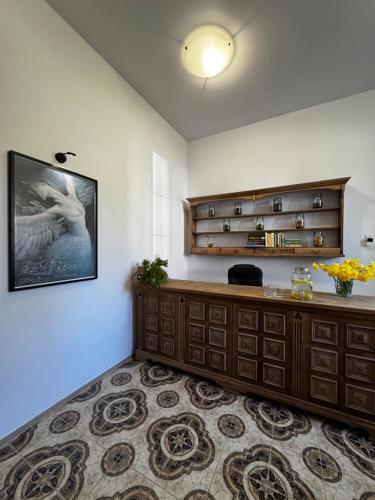 a living room with a dresser and a picture on the wall at Apartament Poranek w Sadzie in Białla