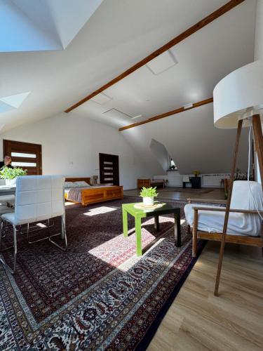 a living room with a couch and a table at Apartament Poranek w Sadzie in Białla
