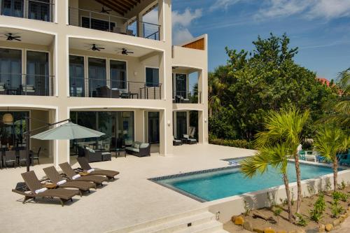 an exterior view of a villa with a swimming pool at Naïa Resort and Spa in Placencia Village
