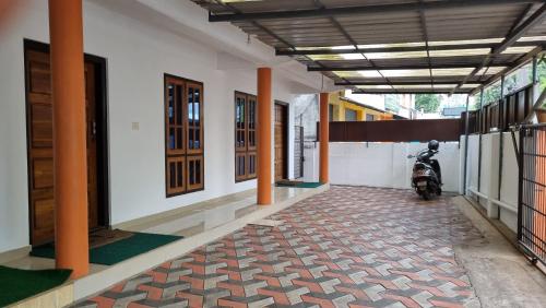 a corridor of a building with a motorcycle parked in it at Anand Munroe Holidays in Munroe Island