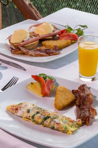 two plates of food on a table with orange juice at Family Selection at Grand Palladium Vallarta Resort & Spa - All Inclusive in Punta Mita