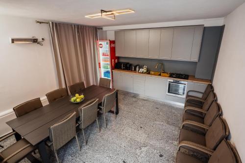 a kitchen with a dining room table and chairs at Aristide House in Bucharest