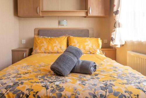 a rolled up towel laying on a bed at 24 Woolacombe Heights - 3 Bed - Sleeps 6 - TJS24WH in Ilfracombe