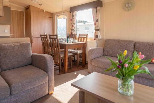 a living room with a couch and a table at 24 Woolacombe Heights - 3 Bed - Sleeps 6 - TJS24WH in Ilfracombe