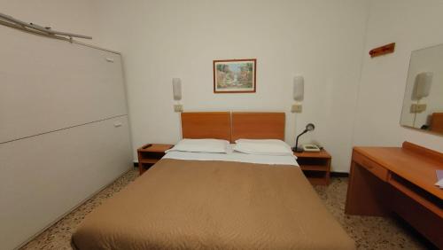 Postel nebo postele na pokoji v ubytování Hotel al Porto