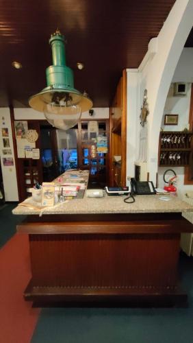 a kitchen with a counter with a green top at Hotel al Porto in Imperia
