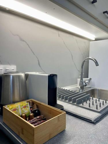a kitchen with a sink and a wooden box at Helia Apartment 2 in Kanálion
