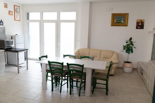 a living room with a white table and chairs at Jungle House - Affitti Brevi Italia in Tarquinia