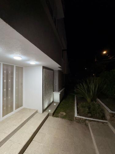 a night time view of a white building at Casa Elegante-Sogamoso in Sogamoso