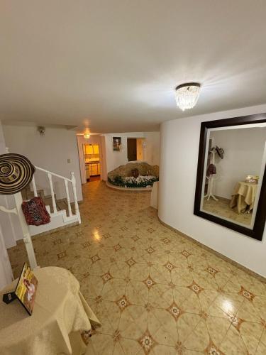 a living room with a table and a mirror at Casa Elegante-Sogamoso in Sogamoso