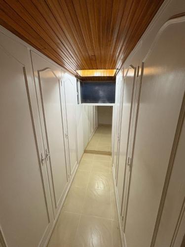 a hallway with white cabinets and a wooden ceiling at Casa Elegante-Sogamoso in Sogamoso