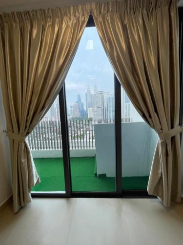 a large window with a view of the city at The Luxe KLCC by Homestay in Kuala Lumpur