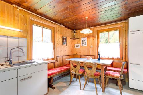 a kitchen with a table and chairs and a sink at Ferienhaus Tribuser in Winkl Heiligenblut