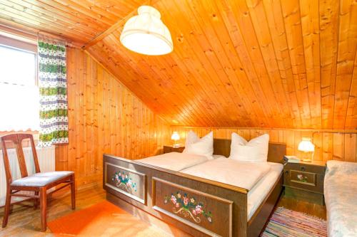 a bedroom with a bed in a wooden room at Ferienhaus Tribuser in Winkl Heiligenblut