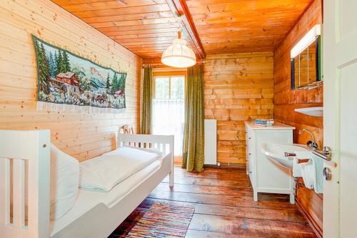 a bedroom with a bed and a sink in a room at Ferienhaus Tribuser in Winkl Heiligenblut
