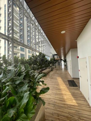 a hallway in a building with plants at The Luxe KLCC by Homestay in Kuala Lumpur