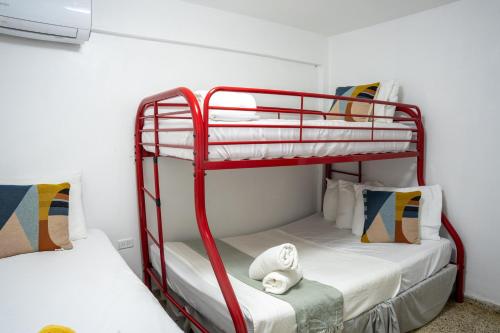 two bunk beds in a room with white walls at Ocean Village at Combate in Cabo Rojo