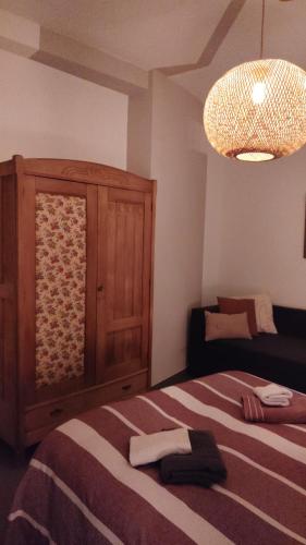 a bedroom with a bed and a cabinet and a light at Norma House on the Rocks in Norma