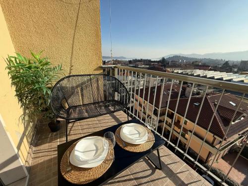 a balcony with a chair and hats on a table at Attico Vista Lago, Relax & Wi-fi in Intra