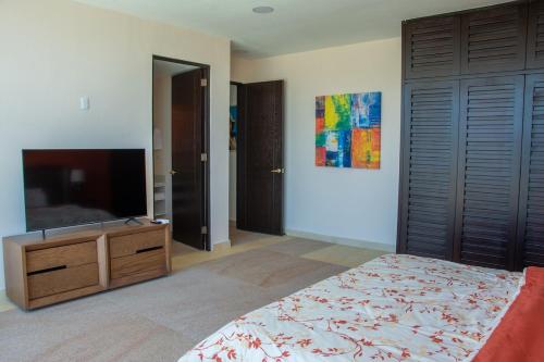 a bedroom with a bed and a flat screen tv at Baja Luxury With Spectacular Ocean Views Ensenada in Marisol