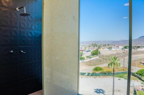 a bathroom with a shower with a view of a street at Baja Luxury With Spectacular Ocean Views Ensenada in Marisol