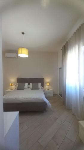 a bedroom with a bed and a large window at Casa Francesca e Rooms in Santa Maria di Castellabate