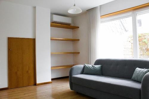 a living room with a couch and a window at Apartamentos Avenida Premium in Vila Real