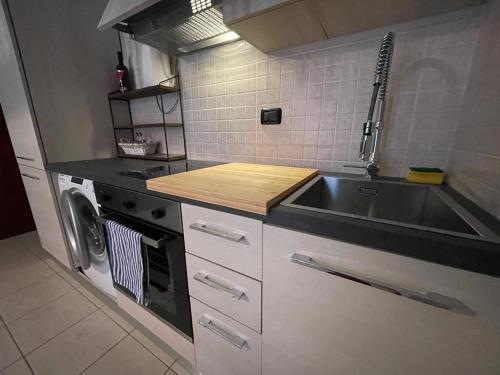 a kitchen with a sink and a stove at Nice apartment with terrace ! in Acquaseria