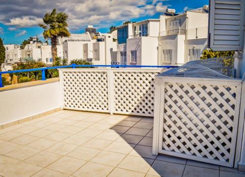 a balcony with white fences and white buildings at Villa Margo by the Sea in Paphos City