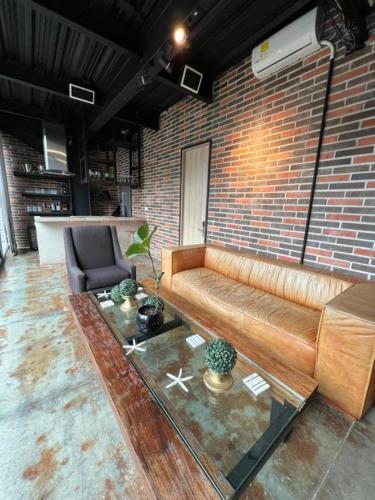 a living room with a couch and a brick wall at Loft Apartamentos Lleras in Medellín
