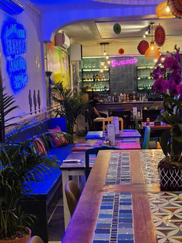 a restaurant with a long table and a bar at Dorothys in Pattaya South
