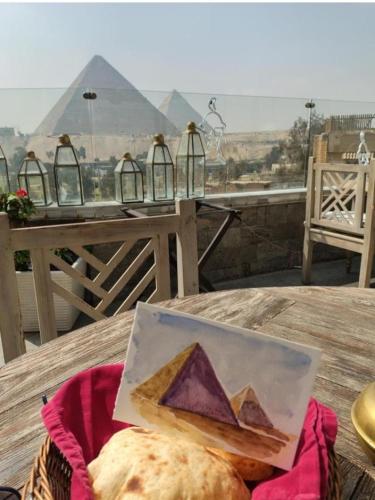 a painting of the pyramids on top of a table at Onyx Pyramids Boutique Hotel in Cairo