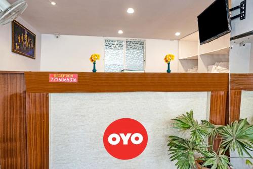 a lobby of a hotel with a ovo sign on the counter at Hotel O Way Point in Méribel Village
