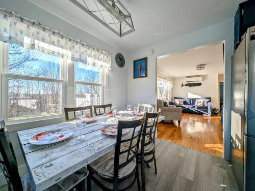 una cucina e una sala da pranzo con tavolo e sedie di Beach Vibes Acadia Cottage Fire pit Family Acadia sleeps 8 a Sullivan