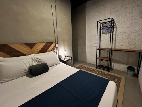 a bedroom with a bed with a blue and white blanket at Loft Apartamentos Lleras in Medellín