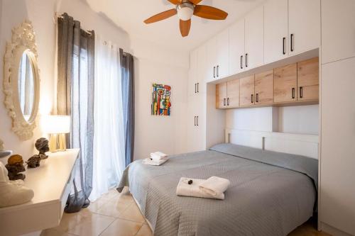 a bedroom with a bed with two towels on it at Arline's Luxury Retreat House in Sarandë