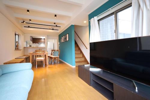 a living room with a large flat screen tv at 渋谷高級一戸建て 貸切 テラス付き 最大七名 in Tokyo