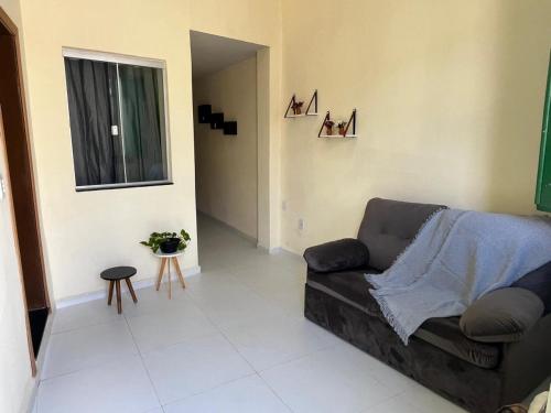 a living room with a couch and a window at Casa da Lapa in Goiás
