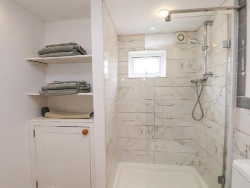 a bathroom with a shower and a glass shower stall at The Barn - Poplar Farm in York