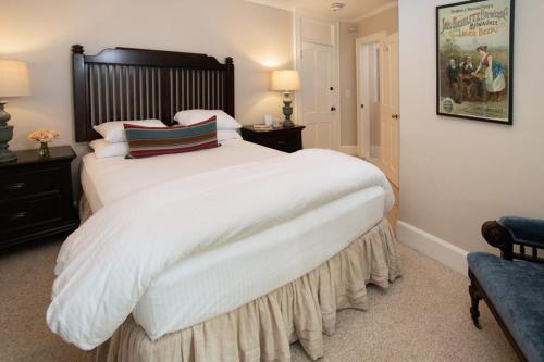 a bedroom with a large bed with white sheets and pillows at The Dorset Inn in Dorset