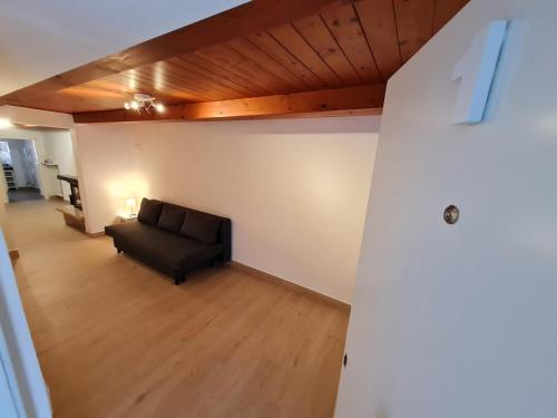 a living room with a black couch in a room at La Corte del Castello - Aeroporto delle Marche - Ancona in Falconara Marittima