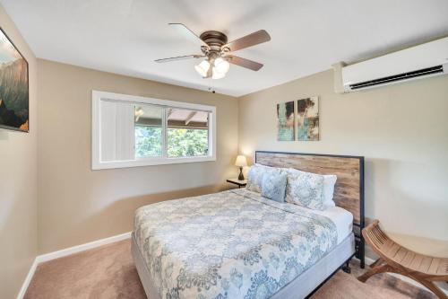 a bedroom with a bed and a ceiling fan at Hale Kahana'lu in Koloa
