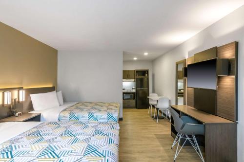 a hotel room with a bed and a desk at Studio 6 Columbus GA Columbus Airport in Columbus
