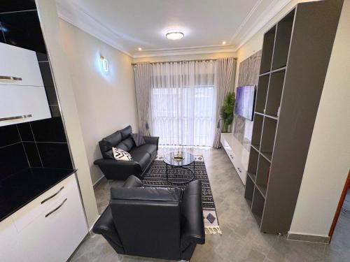 a living room with a couch and a table at Tanzi Homes 1 Manzi in Mbarara