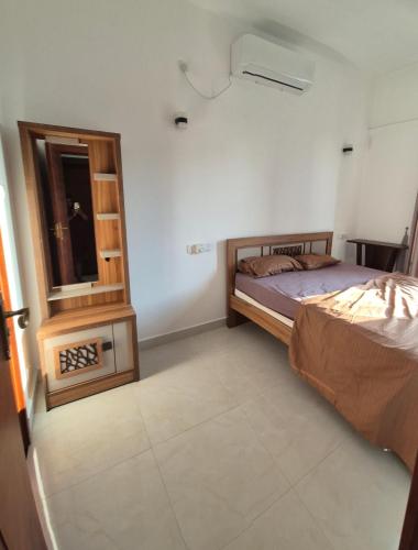 a bedroom with two beds and a window in it at K&S Luxury Apartment in Dehiwala
