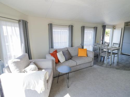 a living room with a couch and a table at Casa De Rhu in Evesham