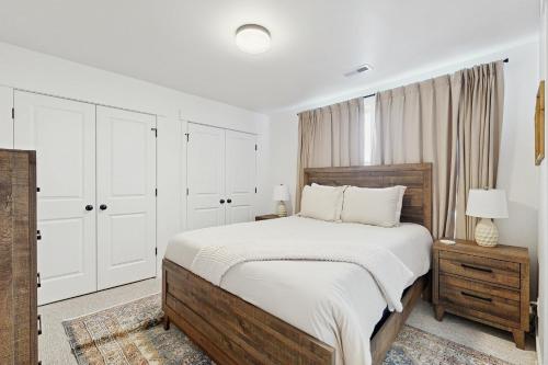 a white bedroom with a large bed and white cabinets at Silver Creek Retreat in Park City