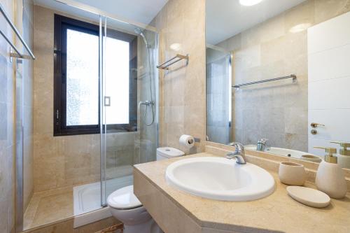 a bathroom with a sink and a toilet and a shower at Apartment with Private Terrace Calanova Golf by AORA STAY in Mijas Costa